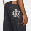 Selvedge-denim-carpenterbukser med løpende hund